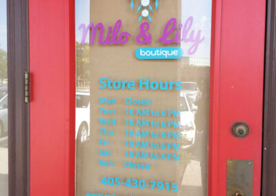 Picture of store front letters and store hours.